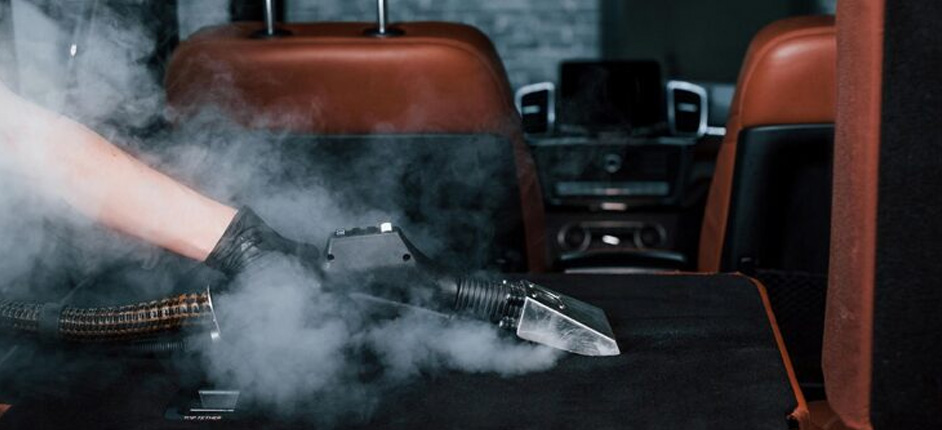 Mobile car interior steam cleaning in Great Falls VA using high-heat equipment to sanitize seats and remove deep dirt.